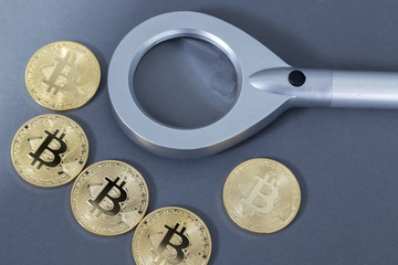 Bitcoin with a magnifying glass