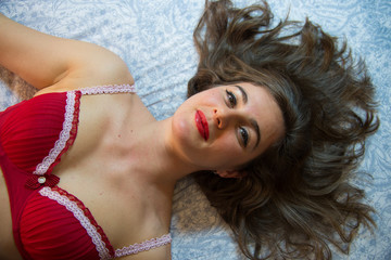 seductive young woman in red bra, with mane hair