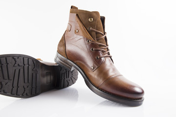 Male brown leather boot on white background, isolated product, comfortable footwear.