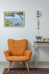 Vintage Furniture - Interior composition of retro orange armchair, vintage wooden beige table, and...