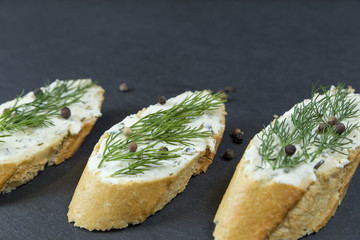 Sliced baguette with butter and dill