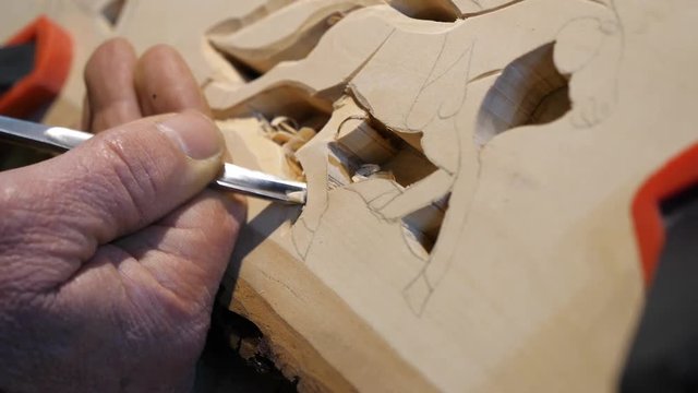 Wood carving - Human hand chiseling, slow motion