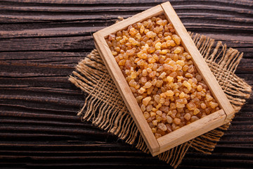 frankincense essential oil on a wooden background