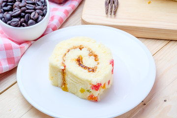 Sliced Cake Roll on wooden background
