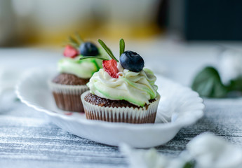 Tasty cupcakes on wooden table