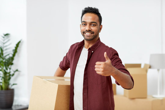 man with box moving to new home showing thumbs up