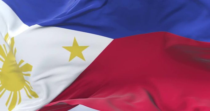 Philippines flag waving at wind in slow with blue sky, loop