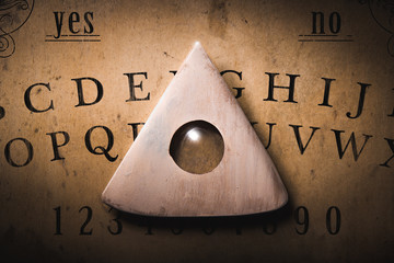 Talking board and planchette used on seances for communicating with the dead, high contrast image