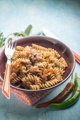 fusilli with fish and hot chili pepper, selective focus