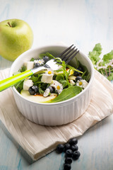 mixed salad with feta apple arugula blueberry and little daisy,selective focus