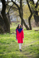 Young lady in coat and sunglasses