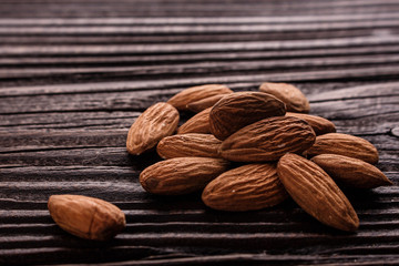 almond essential oil on a wooden background