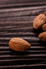 almond essential oil on a wooden background