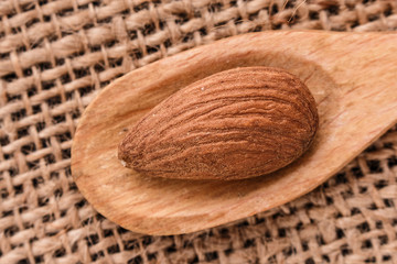 almond essential oil on a wooden background