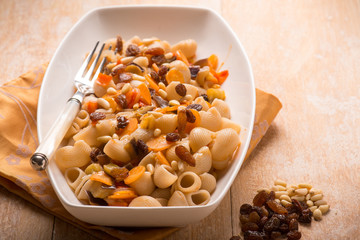 oriental pasta with dried grape pine nuts and carrot, SELECTIVE FOCUS