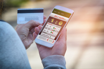 Man betting on sports with smartphone