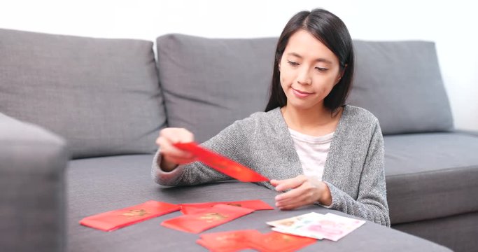 Woman putting money into chinese red packet