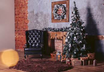Beautiful modern design rooms in dark colors, decorated for Christmas with gift boxes under the Christmas tree