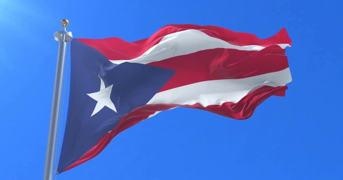 Flag of Puerto Rico waving at wind in slow with blue sky, loop