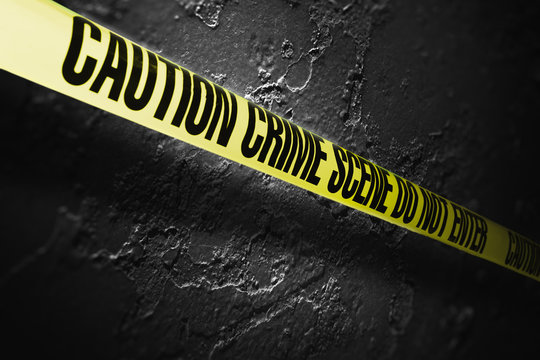 Crime scene tape with a grungy background, high contrast image