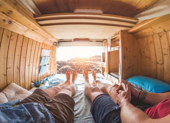 Legs view of happy couple inside minivan