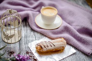 Cup of coffee and sweater on a wooden background