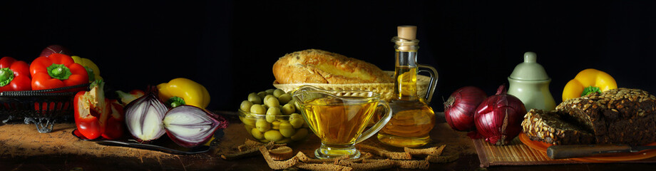 Panorama still life with olive oil and vegetables