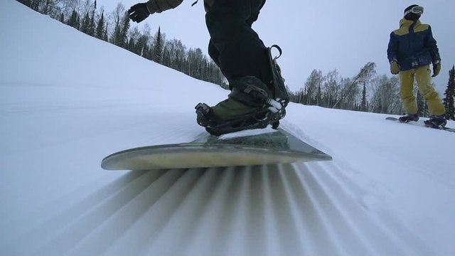 young man snowboarding in the moutain off track