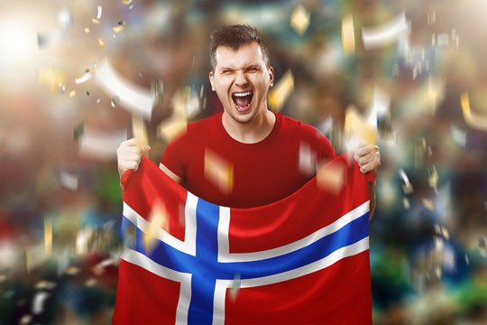 A Norwegian fan, a fan of a man holding the national flag of Norway in his hands. Soccer fan in the stadium. Mixed media