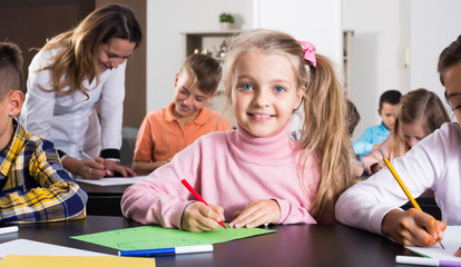  Portrait of happy girl in elementary age drawing