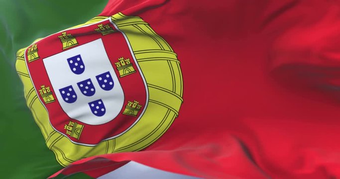 Portugal flag waving at wind in slow with blue sky, loop