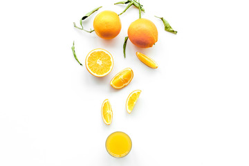 Orange juice in glass near slices of oranges on white background top view copy space