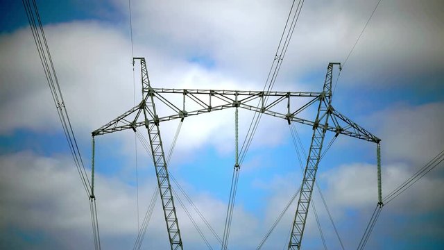 Power line support against the background of the blue sky with clouds