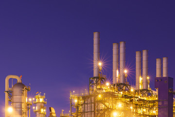 Oil refinery at twilight with sky background
