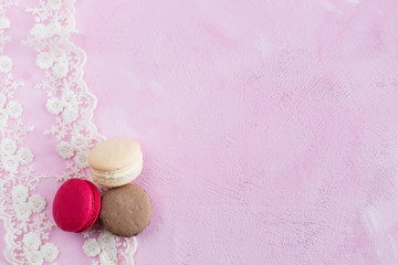Fototapeta na wymiar Dessert macarons on a pink background