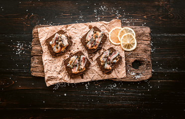bruschetta with delicious fish on a cream cushion with capers and olive oil