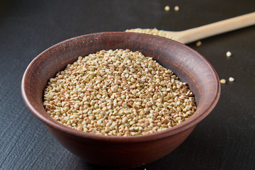 Raw green buckwheat on a black background.