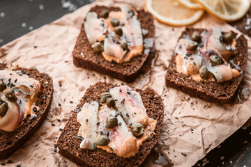 bruschetta with delicious fish on a cream cushion with capers and olive oil