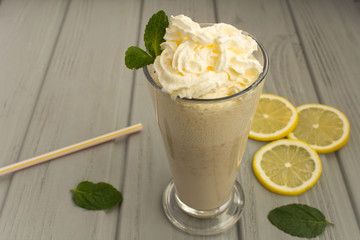 Milk banana cocktail on the  wooden grey background