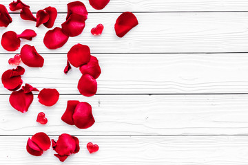 Valentine's day. Red rose petals on white background top view copy space
