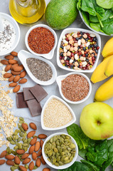 Healthy food nutrition dieting concept. Banana, chocolate, spinach, avocado, apple, quinoa, chia,...