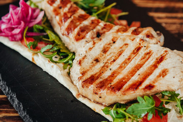 appetizing and delicious grilled meat dish with vegetables and herbs