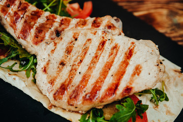 appetizing and delicious grilled meat dish with vegetables and herbs