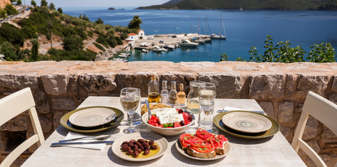 A table served for two with snacks and drinks on the summer terrace of the hotel room by the...