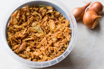 Fried Crispy Onion Flakes in Plastic Package Bowl.