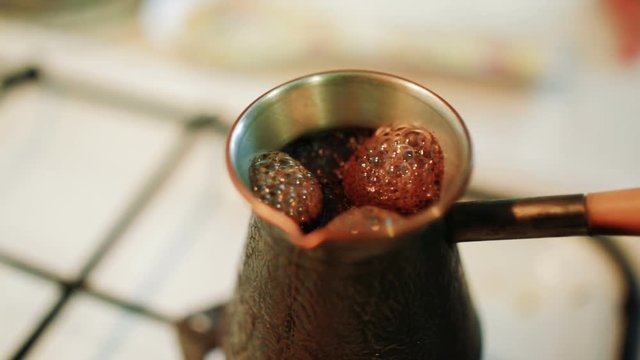 Turka with coffee on the gas stove.