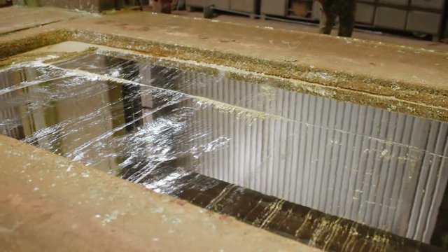 hot dip galvanizing. Industrial worker against the background of a bath with liquid zinc