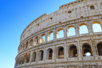 Obraz premium Colosseum Rome. Ruins of the ancient Roman amphitheatre. Travel to Italy, Europe. Crowd and queue. Sunny day and blue sky