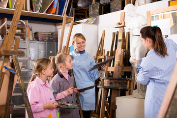 Female teacher explaining painting techniques