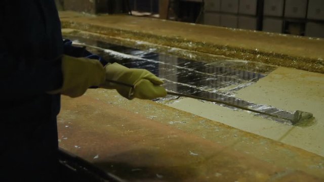 hot dip galvanizing. Industrial worker against the background of a bath with liquid zinc
